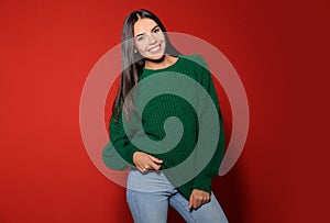 Happy young woman wearing warm sweater