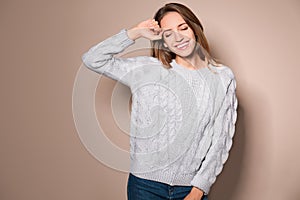 Happy young woman wearing warm sweater