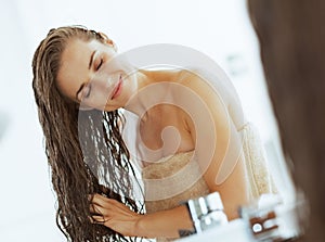 Happy young woman with wet hair in bathroom