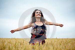 Happy young woman in wheat field