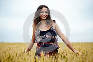 Happy young woman in wheat field