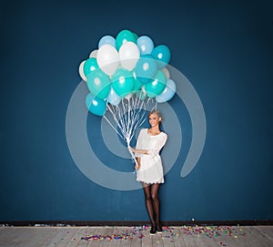 Happy Young Woman in White Dress Holding Balloons