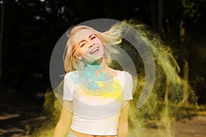 Happy young woman in white t shirt with hair in wind playing wit