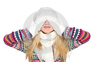 Happy young woman in winter clothes closing eyes