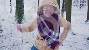 Happy young woman in winter forest. Jump and dance