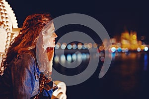 Happy young woman wondering in Budapest night panorama