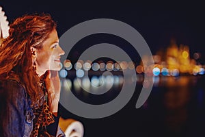 Happy young woman wondering in Budapest night panorama portrait