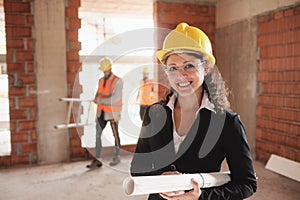 Happy Young Woman Working As Architect In Construction Site