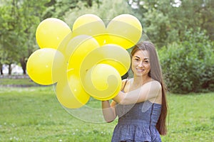 Happy Young Woman With Yellow Balloons