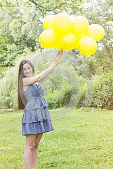 Happy Young Woman With Yellow Balloons