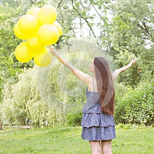 Happy Young Woman With Yellow Balloons