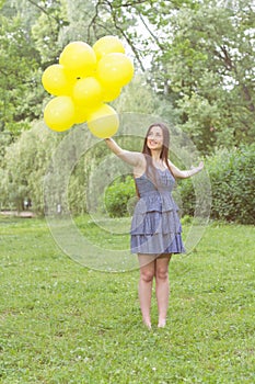 Happy Young Woman With Yellow Balloons