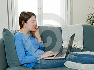 Happy young woman on zoom video calling family and friends using laptop during social distancing