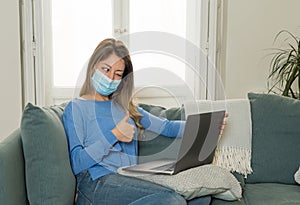 Happy young woman on zoom video calling family and friends using laptop during social distancing