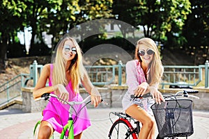 Happy young women on a bicycles in summertime