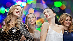 Happy young women dancing at night club disco