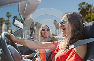 Happy young women driving in car over venice beach