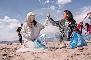 happy young women with grabbers giving