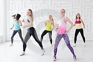 Happy young women having a calorie-burning dance