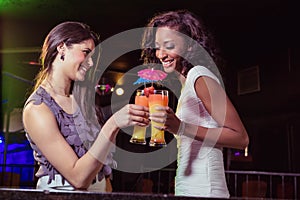 Happy young women having cocktail