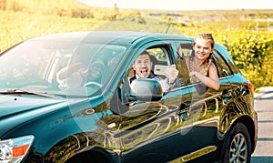 Happy young women and man driver enjoying a summerâ€™s road trip together. Road trip Hangouts