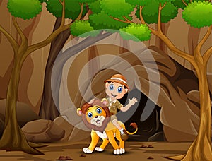 Happy zookeeper boy and lion in front the cave