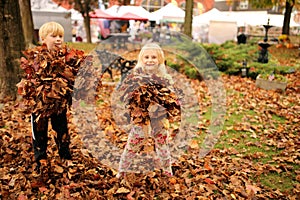 Hapy Little Kids Playing in the Leaves at a Fall Festival