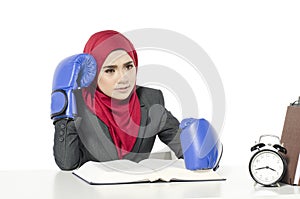 Hapyy face young businesswoman in suit with boxing glove