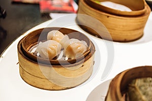 Har Gow: Steamed thin flour sheet wrap with shrimp in bamboo basket at the restaurant in Dubai