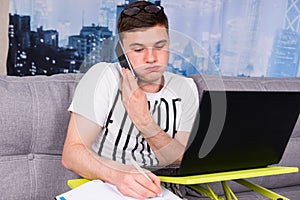 Harassed young man working from home photo