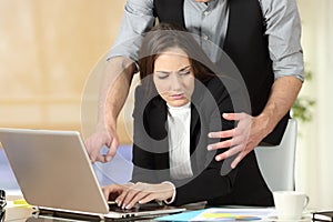 Harassment with a boss touching to his secretary photo