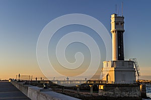 Harbor on the Basque coast and the lighthouse at sunset