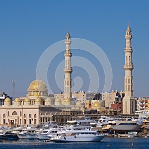 Harbor with boats and mosque at Hurghada on Red Sea in Egypt