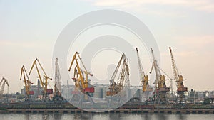 Harbor cranes on sky background.