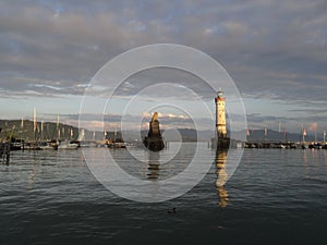 Harbor entrance in Lindau on Lake Constance with the landmark lion and lighthouse, Bavaria, Germany