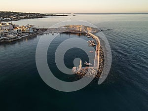 The harbor of the famous resort Chersonissos on Crete, Greece during sunset