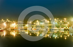 Harbor fishing boats at night with beautiful lights. Siglufjordur, Iceland.