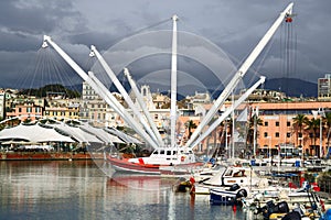 Harbor of Genoa against dramatic clouds. Porto Antico, Il Bigo. Liguria, Italy.