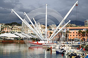 Harbor of Genoa against dramatic clouds. Porto Antico, Il Bigo. Liguria, Italy. photo