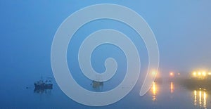 Harbor Harbour sea ocean water with fishing boats early evening with thick sea fog