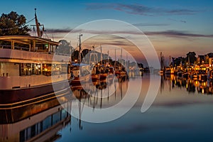 A harbor with many small boats at night