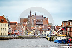 Harbor in the old town of the hanseatic city of Wismar, view on historic houses and the red-brick Georg church, travel destination