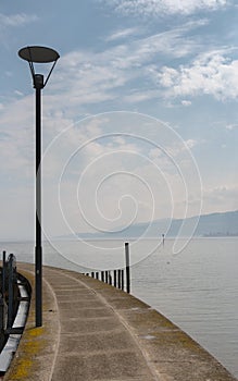 Harbor pier and jetty with a great lake view and a lantern in the foreground