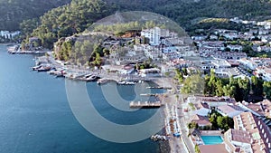 Harbor and port in resort village with moored touristic boats and ships. Marina in Turunc. Boat taxi to move tourists