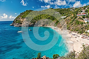 Harbor with sand beach, blue sea and mountain landscape in gustavia, st.barts. Summer vacation on tropical beach