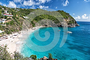 Harbor with sand beach, blue sea and mountain landscape in gustavia, st.barts. Summer vacation on tropical beach. Recreation, leis