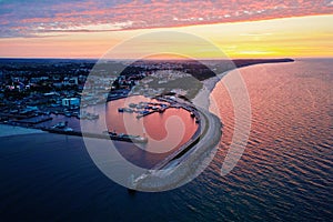 Harbor with ship sailing to port during sunset