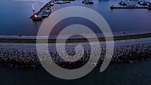 Harbor with ship sailing to port during sunset