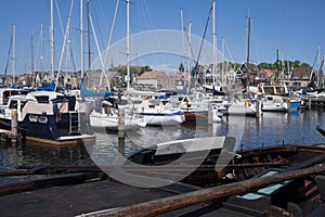 Harbor of small Dutch fishing town Urk with fishing and sailing boats