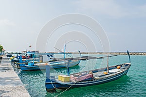 Harbor with small fishermen`s boats located at the tropical island Villingili